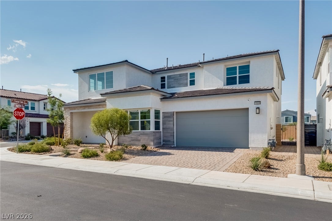 10226 Pleasant Knoll Avenue, Las Vegas, NV 89166 Modern architectural lines define this dual-level residence with integrated garage and stone details.
