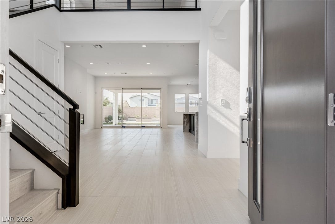 10226 Pleasant Knoll Avenue, Las Vegas, NV 89166 A spacious entryway reveals soaring ceilings, and a modern open floorplan.