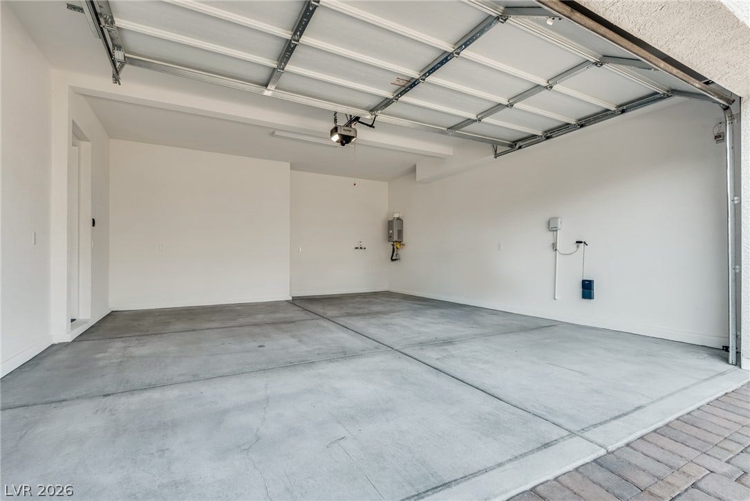 10226 Pleasant Knoll Avenue, Las Vegas, NV 89166 2 car garage showing tankless water heater & soft water loop.