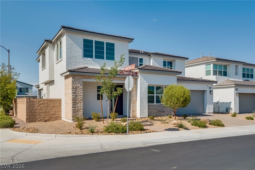 10226 Pleasant Knoll Avenue, Las Vegas, NV 89166 Modern architecture defines this two-story home featuring clean exterior lines and a stone-accented entryway.