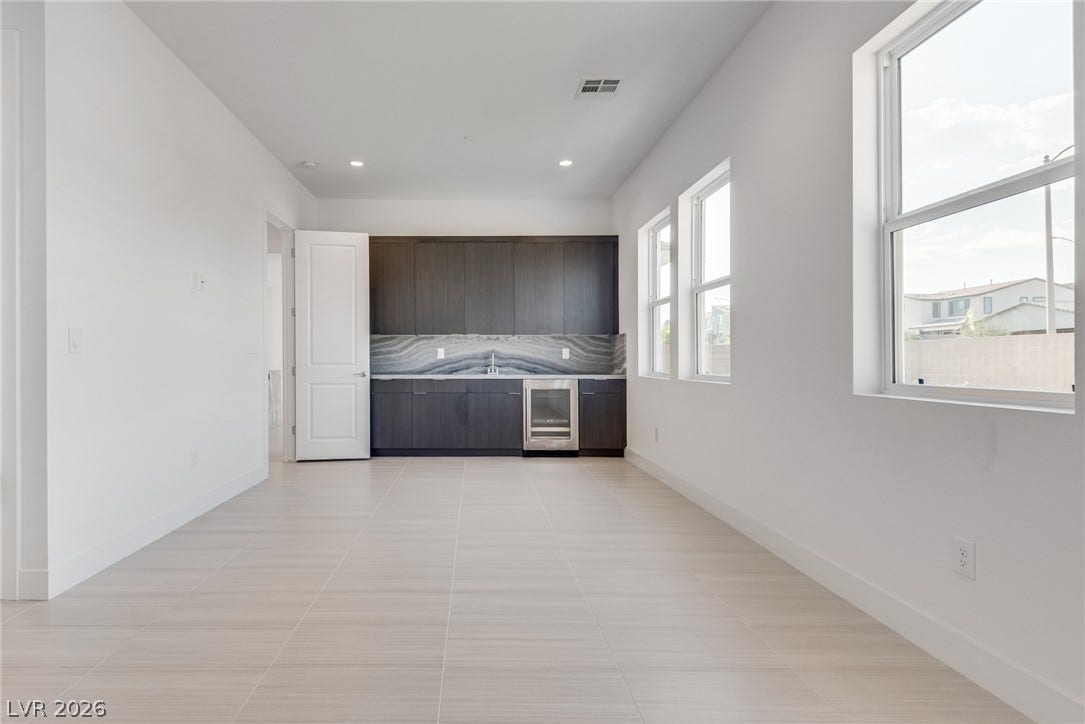 10226 Pleasant Knoll Avenue, Las Vegas, NV 89166 Downstairs flex suite: can be used for variety of purpose. It comes with sink, wine fridge, cabinetry & beautiful counter tops.