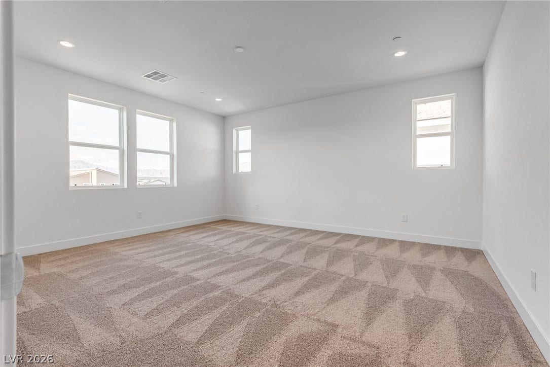 10226 Pleasant Knoll Avenue, Las Vegas, NV 89166 Plentiful windows fill this primary bedroom with natural light.