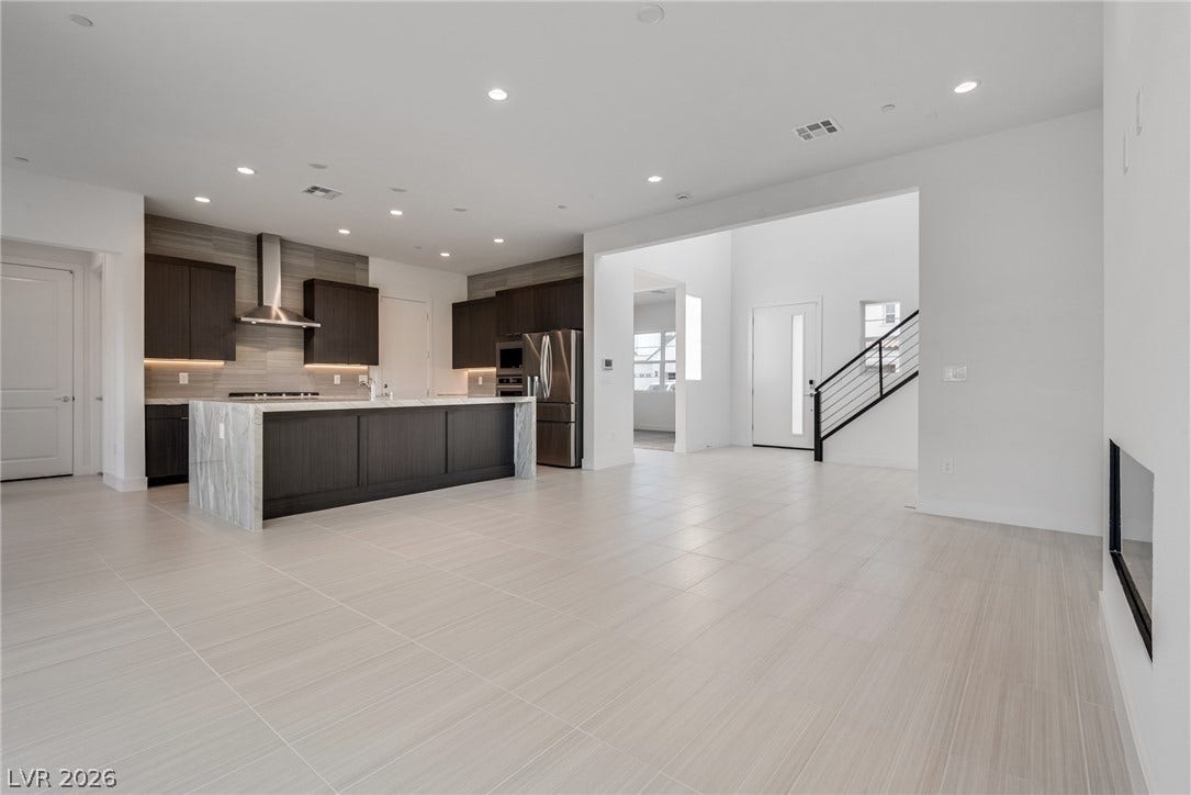 10226 Pleasant Knoll Avenue, Las Vegas, NV 89166 Clean lines and a spacious open floorplan define this modern living and kitchen area.