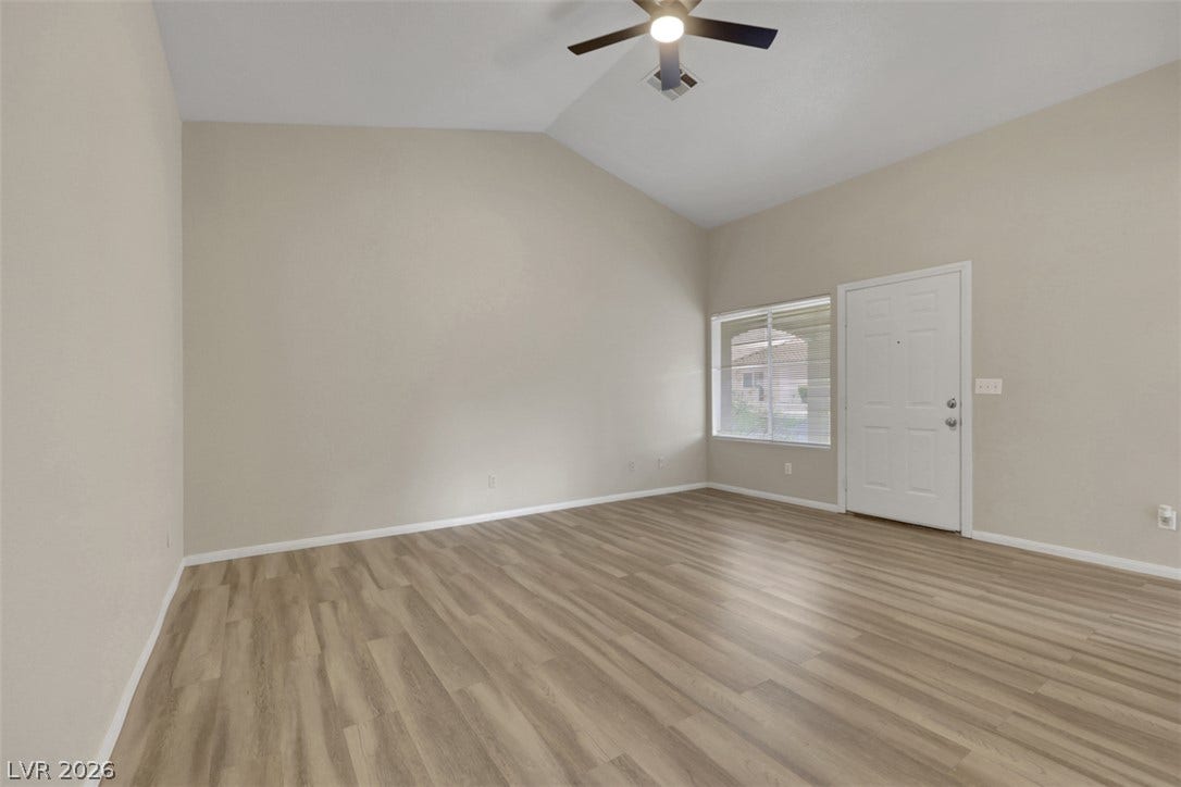 657 Anne Lane, #657, Henderson, NV 89015 Vaulted ceilings and wood-style flooring elevate this versatile entryway space.