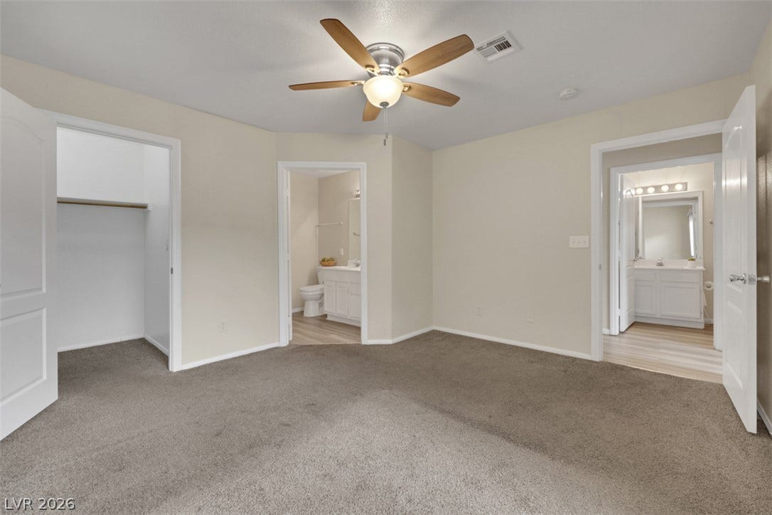 657 Anne Lane, #657, Henderson, NV 89015 Plush carpeting underfoot complements neutral walls and multiple doorways leading to adjacent amenities.