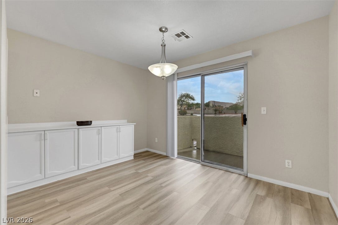 657 Anne Lane, #657, Henderson, NV 89015 A sliding glass door opens to the private balcony from this light-filled dining space.