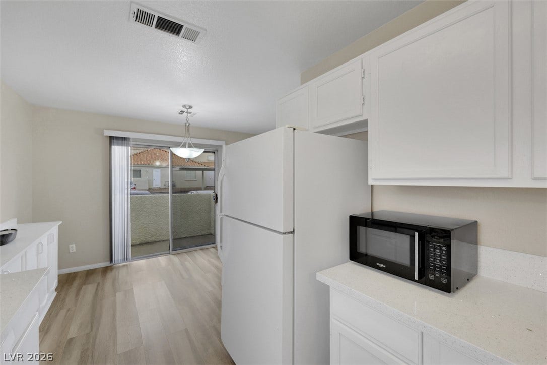 657 Anne Lane, #657, Henderson, NV 89015 Sliding glass doors open from the kitchen and dining area directly to the patio.