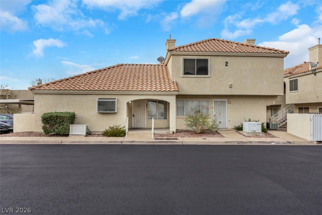657 Anne Lane, #657, Henderson, NV 89015 Spanish tile roofing and classic stucco exterior define this multi-level residential structure.