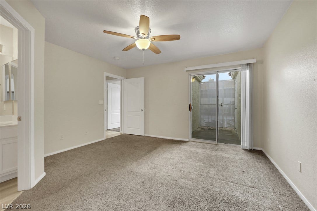 657 Anne Lane, #657, Henderson, NV 89015 Glass sliding doors open from this carpeted bedroom directly onto a private patio area.