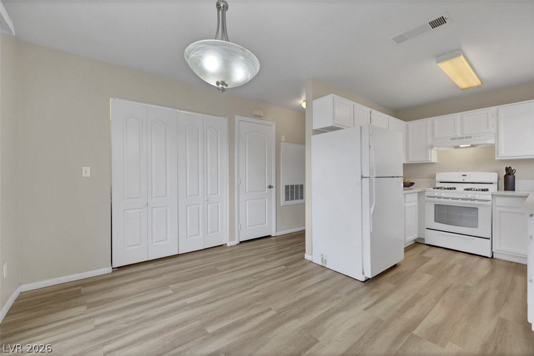 657 Anne Lane, #657, Henderson, NV 89015 Smooth wood-plank flooring connects the bright dining area directly to the kitchen.