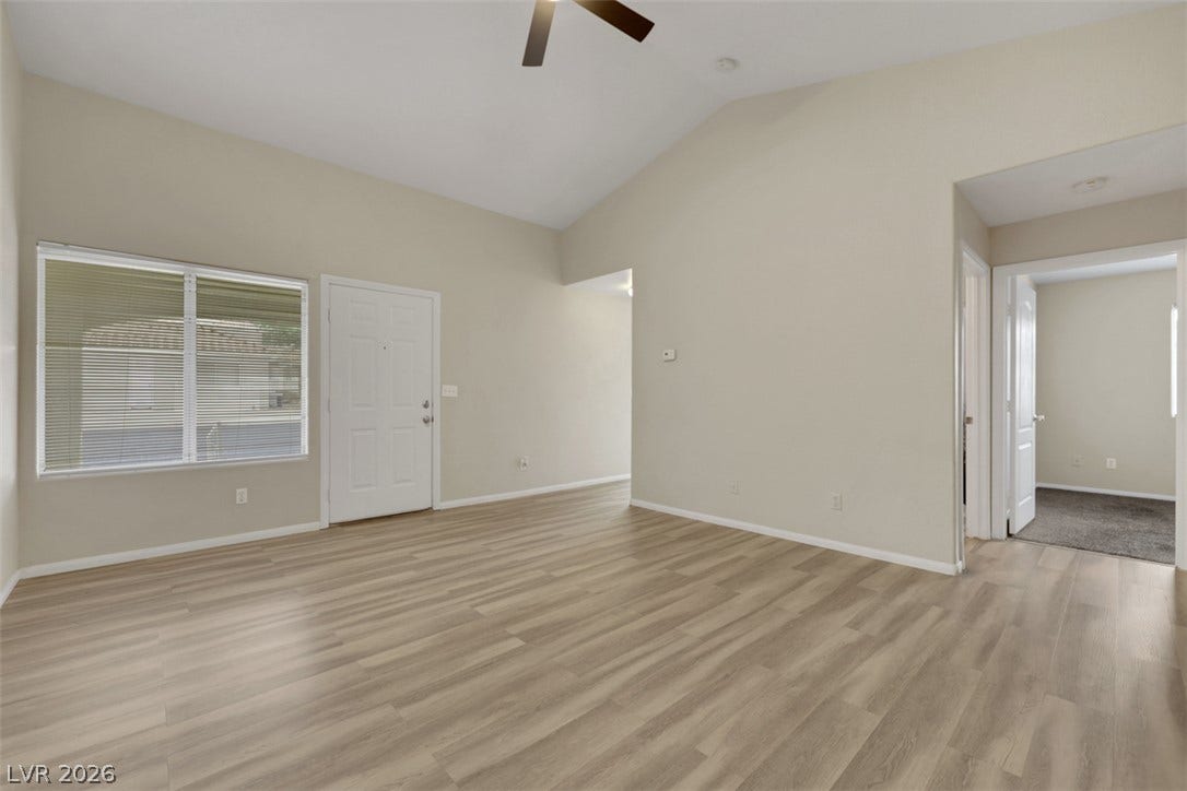 657 Anne Lane, #657, Henderson, NV 89015 An open living space features durable wood-look flooring and a high vaulted ceiling.