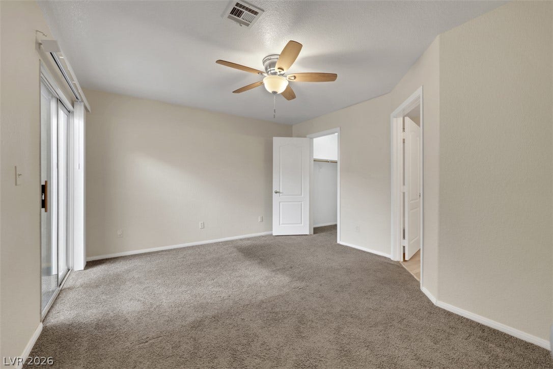 657 Anne Lane, #657, Henderson, NV 89015 Sliding glass doors open from a neutral bedroom with plush carpeting.
