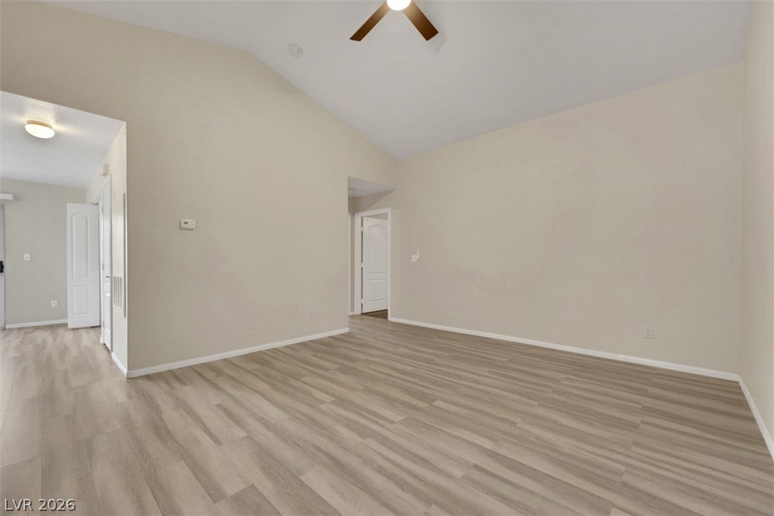 657 Anne Lane, #657, Henderson, NV 89015 Vaulted ceilings and wood-look flooring enhance the open architectural design of this living space.