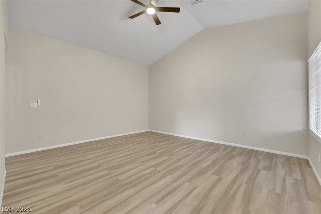 657 Anne Lane, #657, Henderson, NV 89015 Vaulted ceilings and wood-style flooring elevate this versatile, open living space.