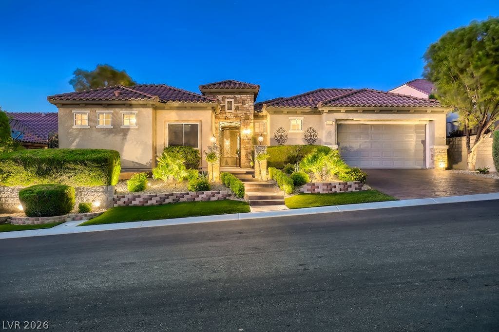 2284 Savannah River Street, Henderson, NV 89044 Stone accents and manicured desert landscaping frame the entryway of this elegant single-story home.
