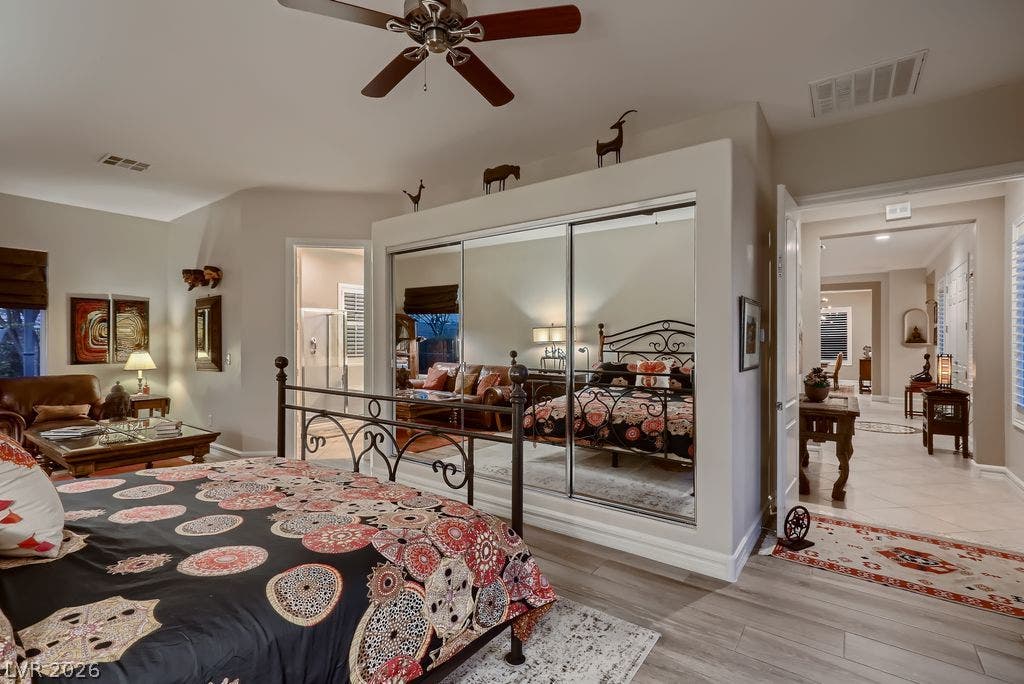 2284 Savannah River Street, Henderson, NV 89044 Plentiful natural light and clean flooring highlight this primary suite with mirrored closet doors.