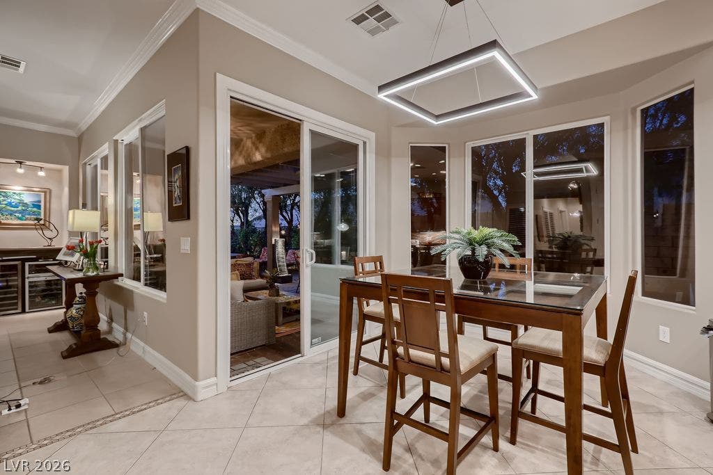 2284 Savannah River Street, Henderson, NV 89044 Tiled flooring and crown molding frame this inviting dining space with views of the patio.