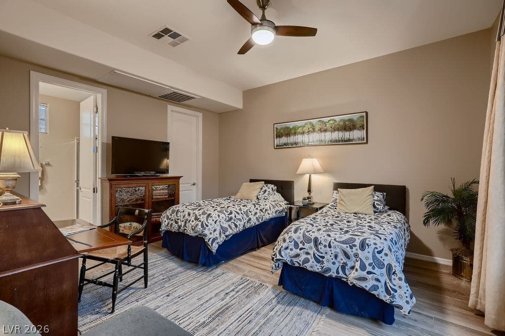 2284 Savannah River Street, Henderson, NV 89044 Gleaming wood-look floors complement high ceilings in this tranquil secondary bedroom suite.