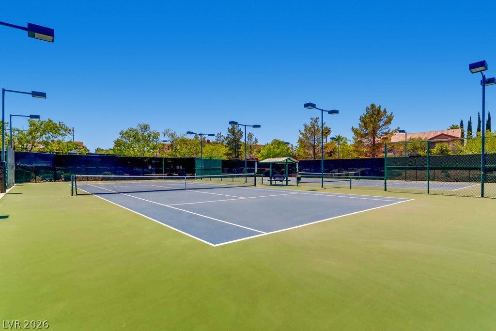 2284 Savannah River Street, Henderson, NV 89044 Professional-grade outdoor tennis courts sit under a clear blue sky surrounded by fencing.