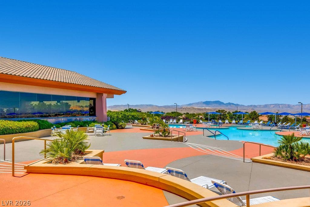 2284 Savannah River Street, Henderson, NV 89044 Expansive outdoor swimming pool deck overlooks distant desert mountain ranges under clear blue skies.