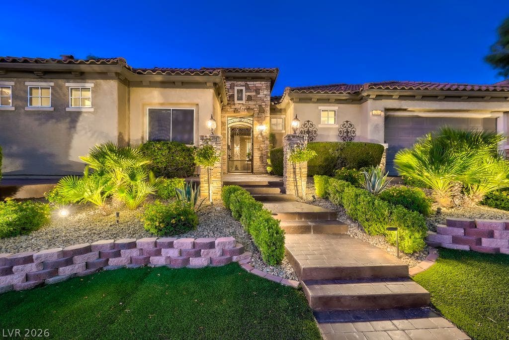 2284 Savannah River Street, Henderson, NV 89044 Manicured pathways and lush desert plantings guide the way to a stone-accented entryway.
