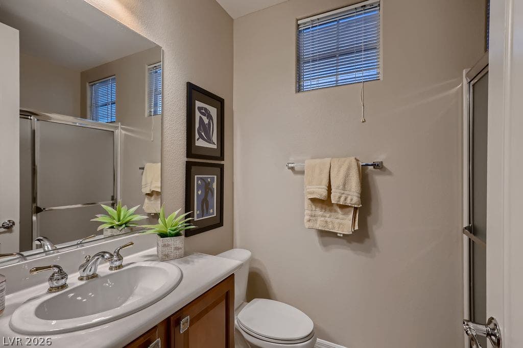 2284 Savannah River Street, Henderson, NV 89044 High ceilings and a neutral palette create a serene atmosphere in this functional bathroom.