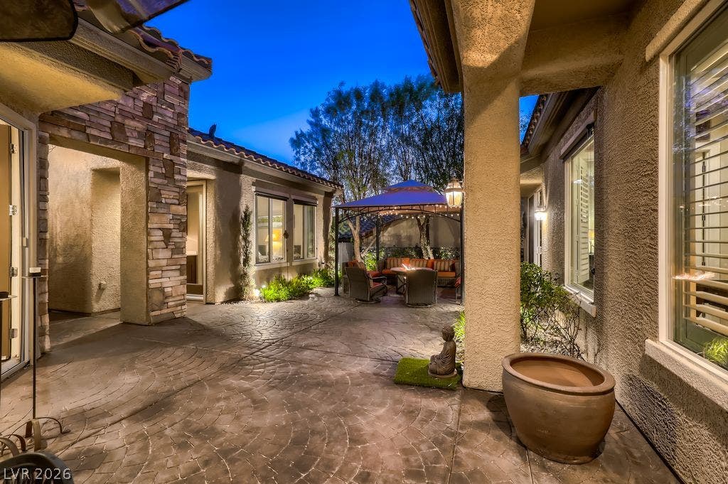 2284 Savannah River Street, Henderson, NV 89044 Stamped concrete finishes enhance this private courtyard under a clear twilight sky.
