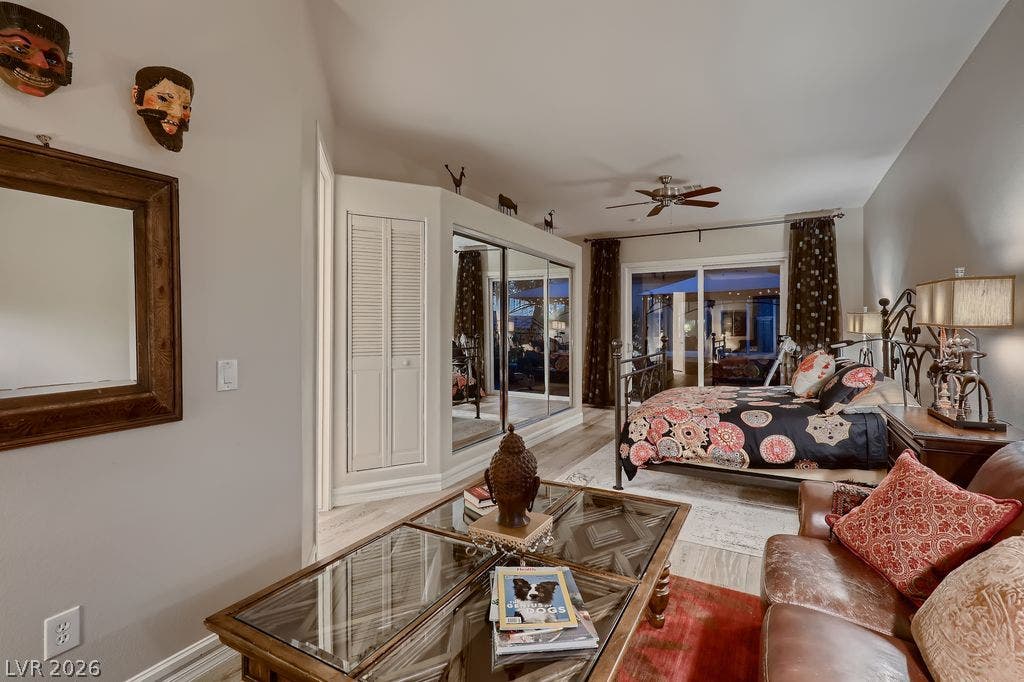 2284 Savannah River Street, Henderson, NV 89044 Glass sliding doors lead outdoors from this bedroom with wood floors and built-in closet storage.