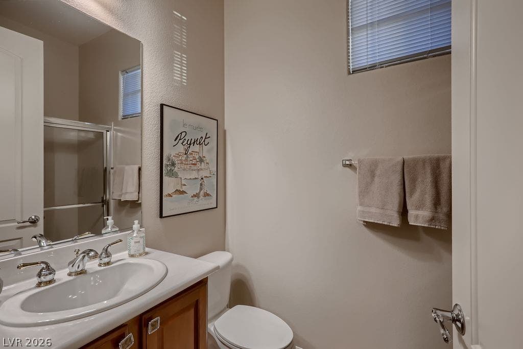 2284 Savannah River Street, Henderson, NV 89044 High ceilings and a transom window bring architectural dimension to this functional bathroom.