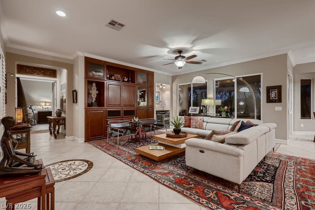 2284 Savannah River Street, Henderson, NV 89044 An open living room features expansive tile flooring, custom built-in cabinetry, and high ceilings.