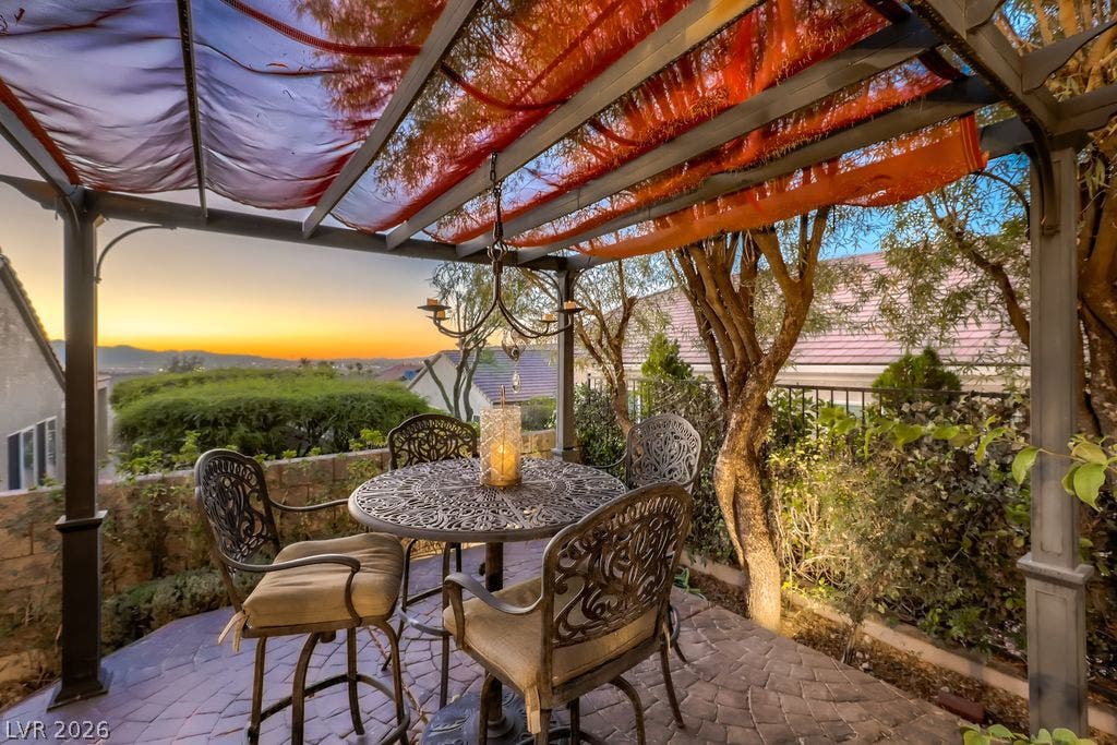 2284 Savannah River Street, Henderson, NV 89044 A shaded pergola-covered patio frames peaceful sunset and neighborhood views.