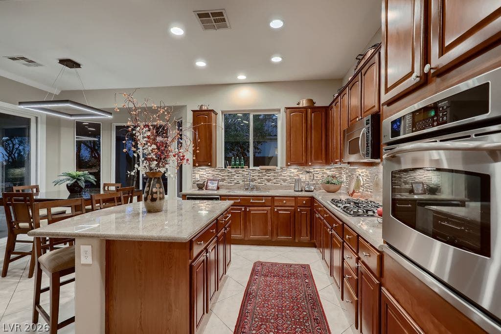 2284 Savannah River Street, Henderson, NV 89044 Gleaming stone countertops and classic wood cabinetry define this open culinary space.