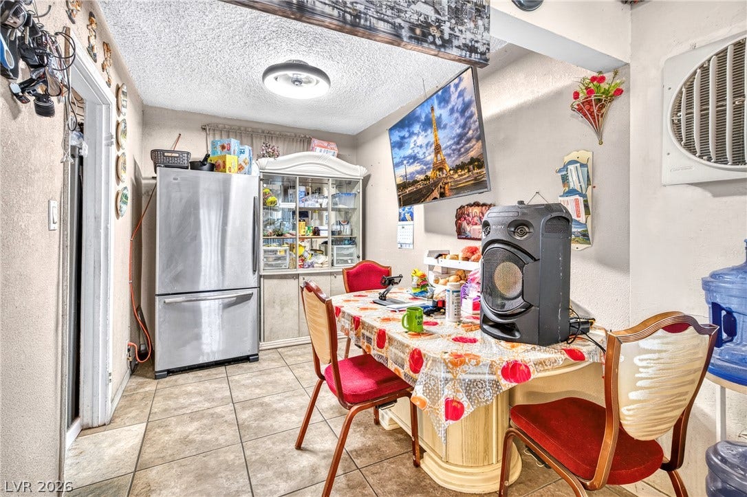 Tiled flooring and a texture-finished ceiling ground this cozy eating area.