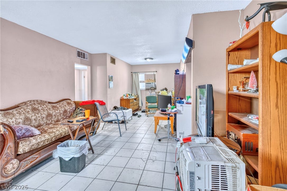 Tiled flooring and neutral walls define this functional living space.
