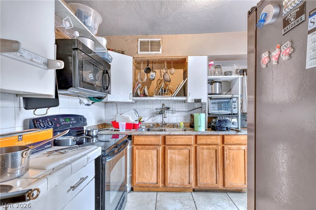 Tiled flooring pairs with classic wood cabinetry in this functional cooking space.