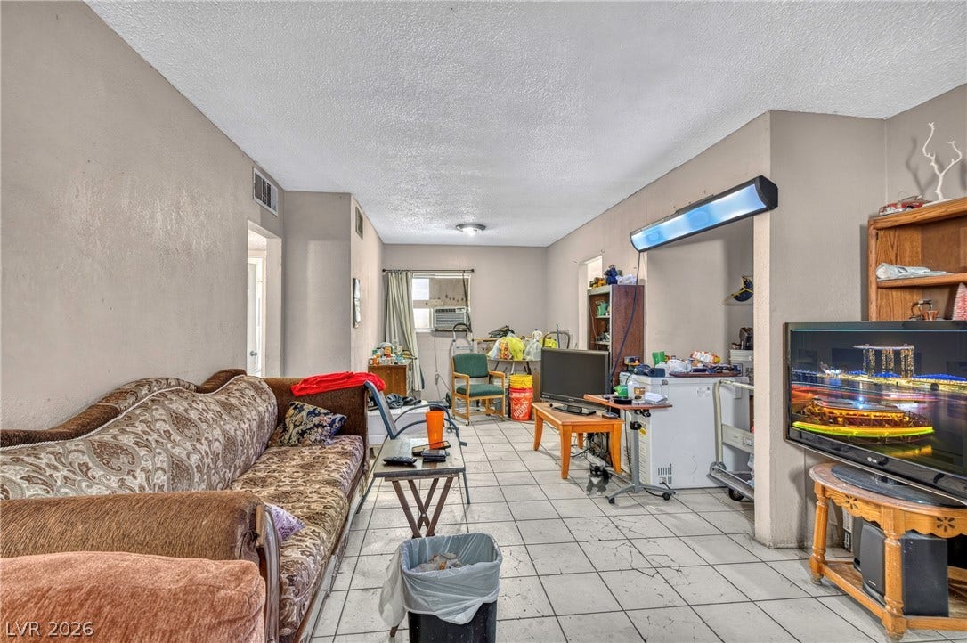 Tiled flooring and neutral walls define this versatile main living area.
