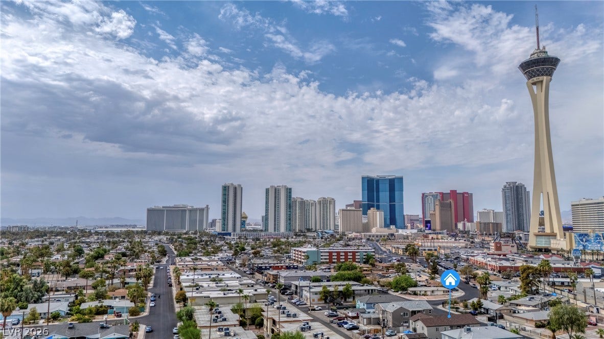 Dramatic panoramic vistas sweep across the city skyline under a wide desert sky.