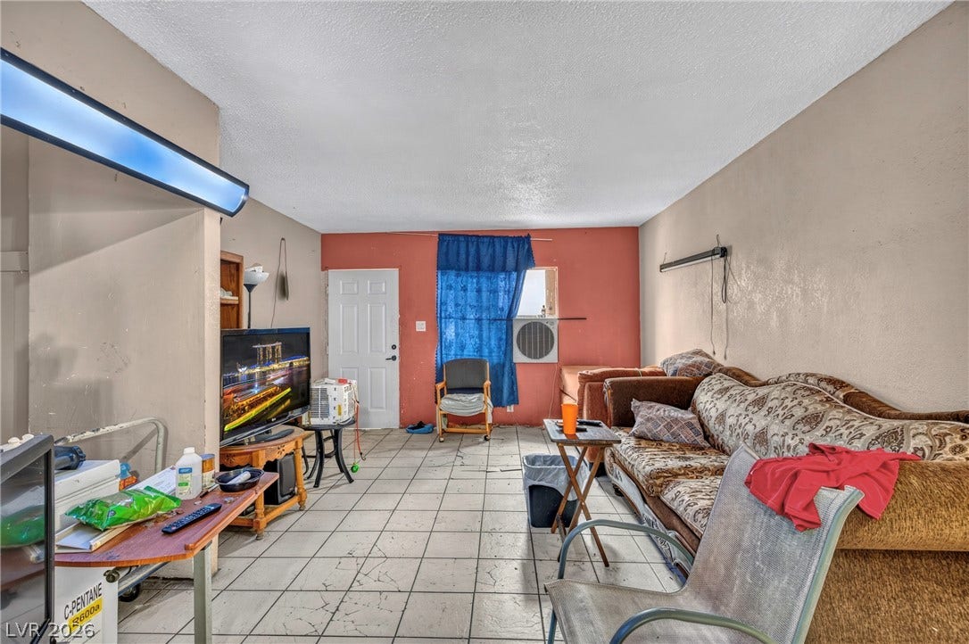 Tiled flooring and neutral walls anchor this functional living area.