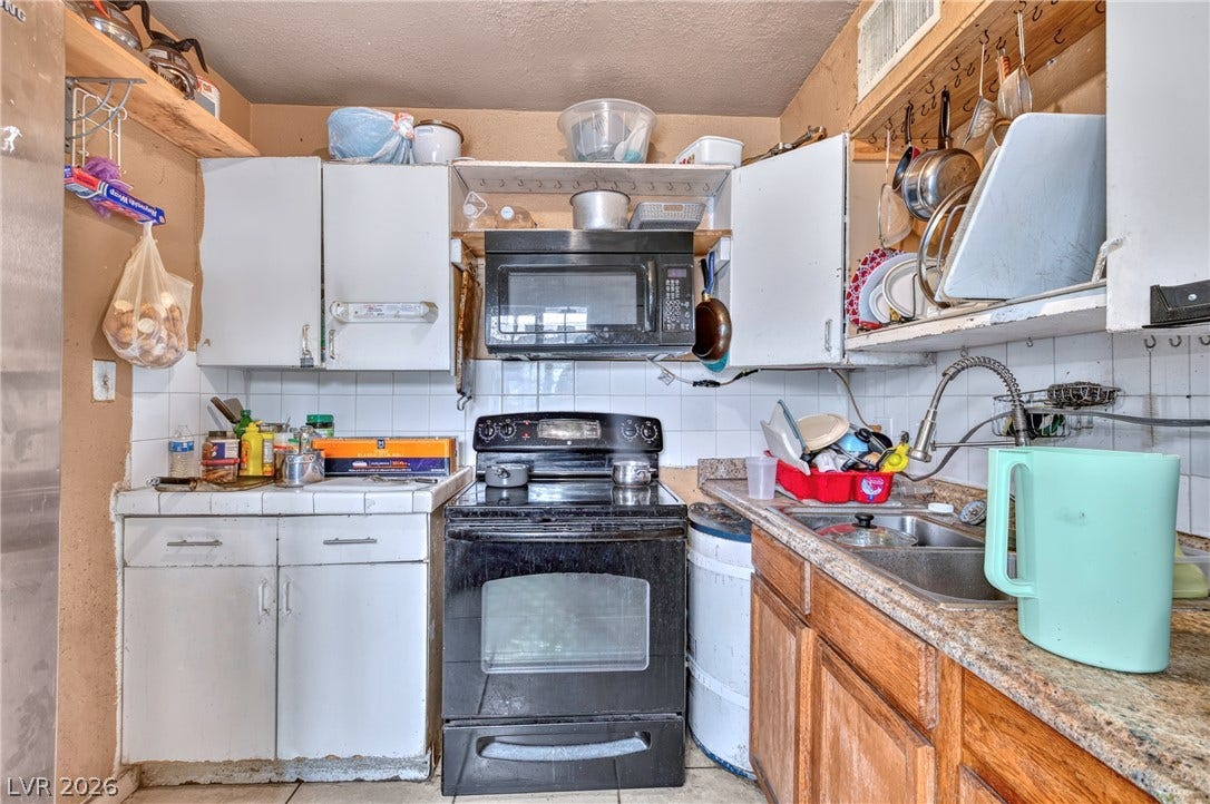 Functional kitchen design with wood cabinets, tiled backsplashes, and integrated cooking appliances.