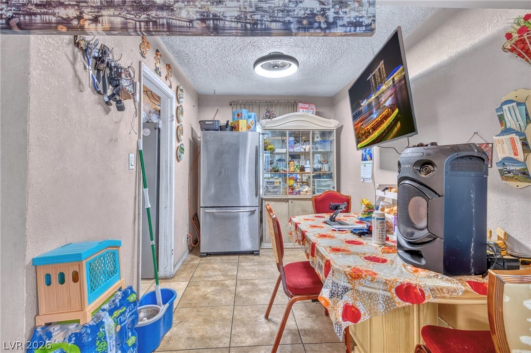 An inviting dining space connects seamlessly with the tiled kitchen floor.