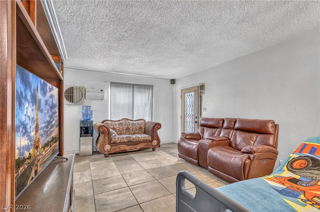 Tiled flooring and neutral walls define this functional living space.