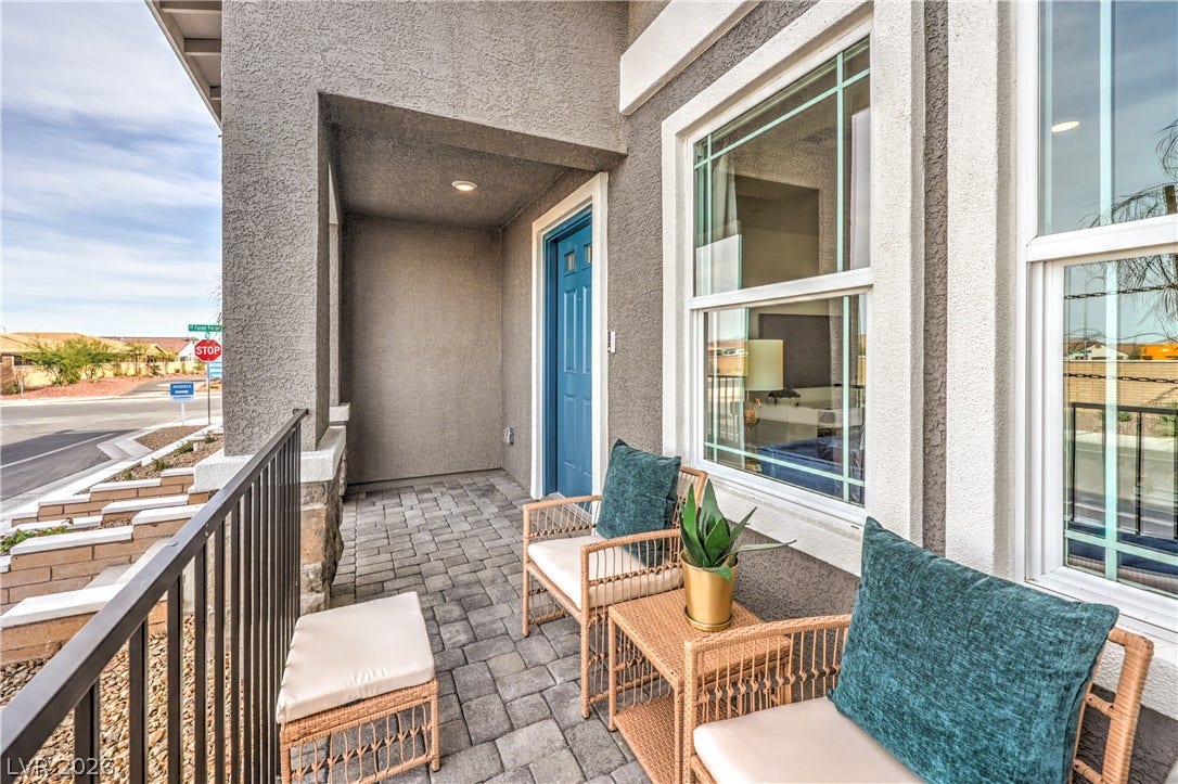 906 Pink Sugarbird Street, Henderson, NV 89011 Welcoming covered porch features neat brick pavers, stucco pillars, and large windows.