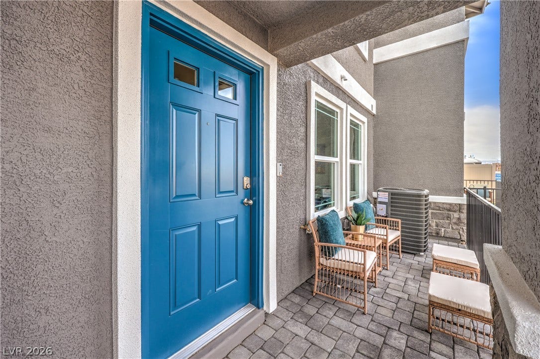 906 Pink Sugarbird Street, Henderson, NV 89011 Welcoming covered porch features textured stucco walls and stylish paver stone flooring.