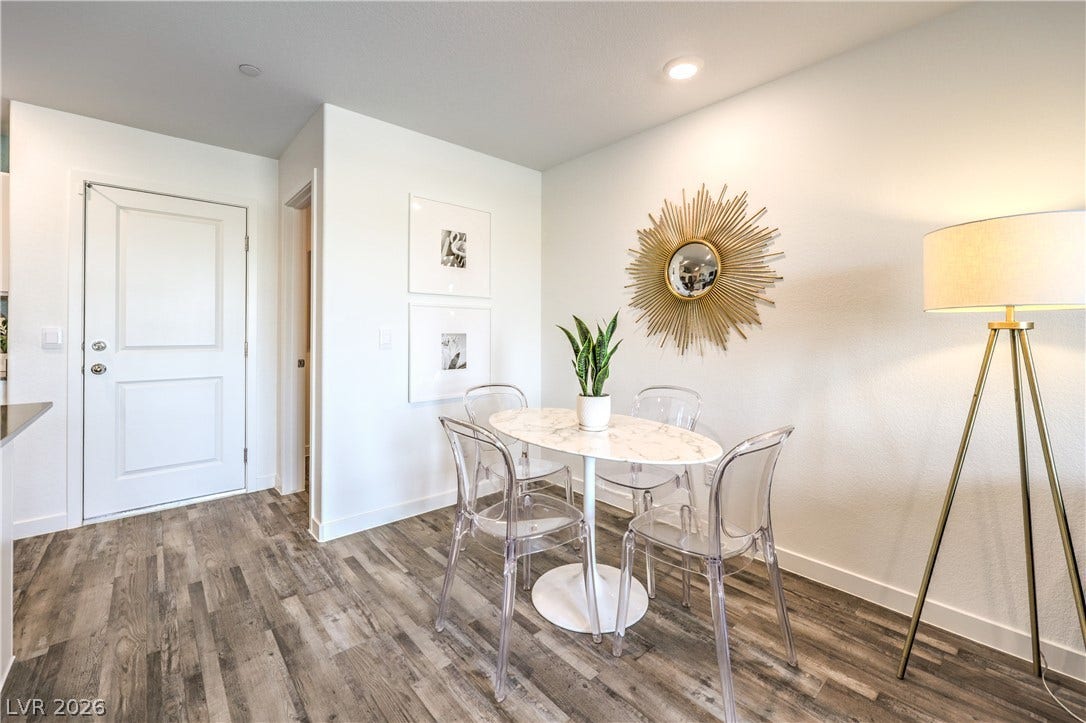 906 Pink Sugarbird Street, Henderson, NV 89011 An inviting dining space features clean white walls and textured wood-look flooring.