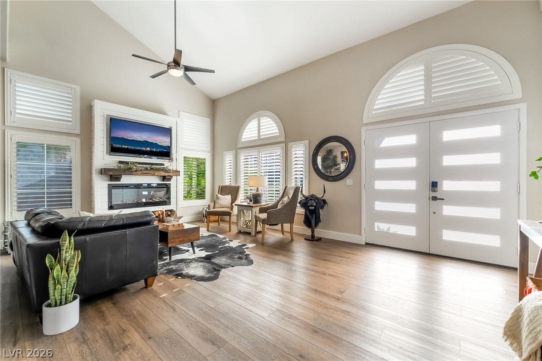Vaulted ceilings and rich wood floors frame this welcoming entryway and open living space.