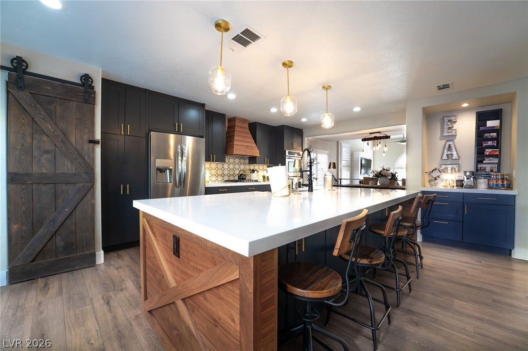 Gleaming stone countertops and a substantial central island anchor this modern culinary workspace.