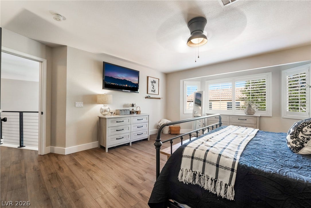 Gleaming hardwood floors and a bright bay window highlight this inviting bedroom retreat.