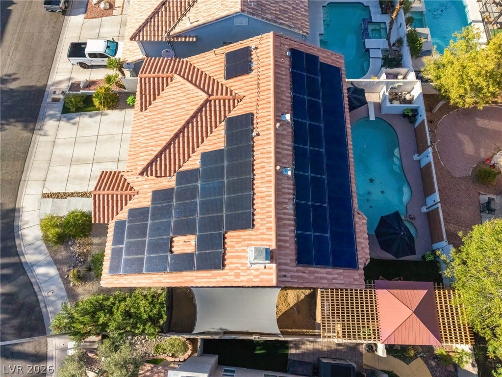 An aerial perspective showcases the tiled roof equipped with modern solar panels.