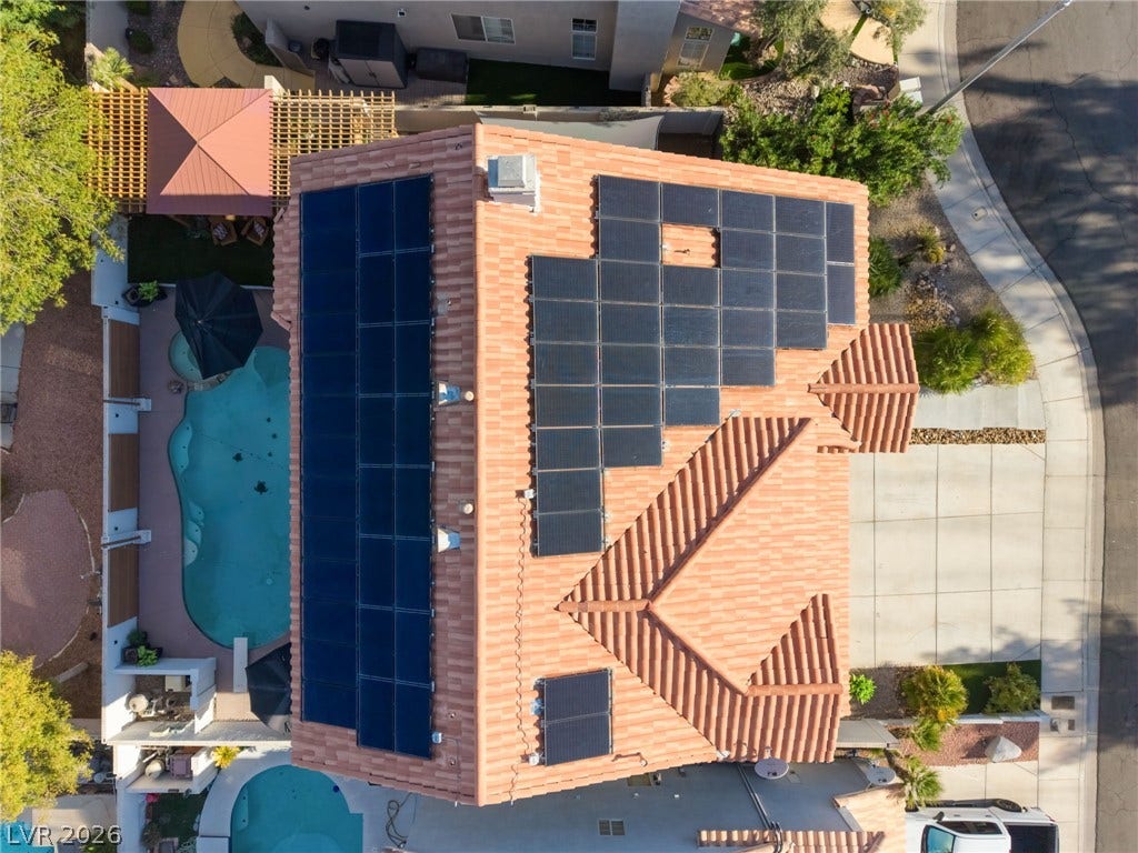 An aerial perspective showcases the solar panel array on a classic tile roof.