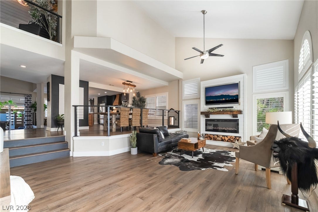 High ceilings and warm wood floors define this architectural, multi-level living area.